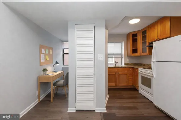 a kitchen with a refrigerator and a stove top oven