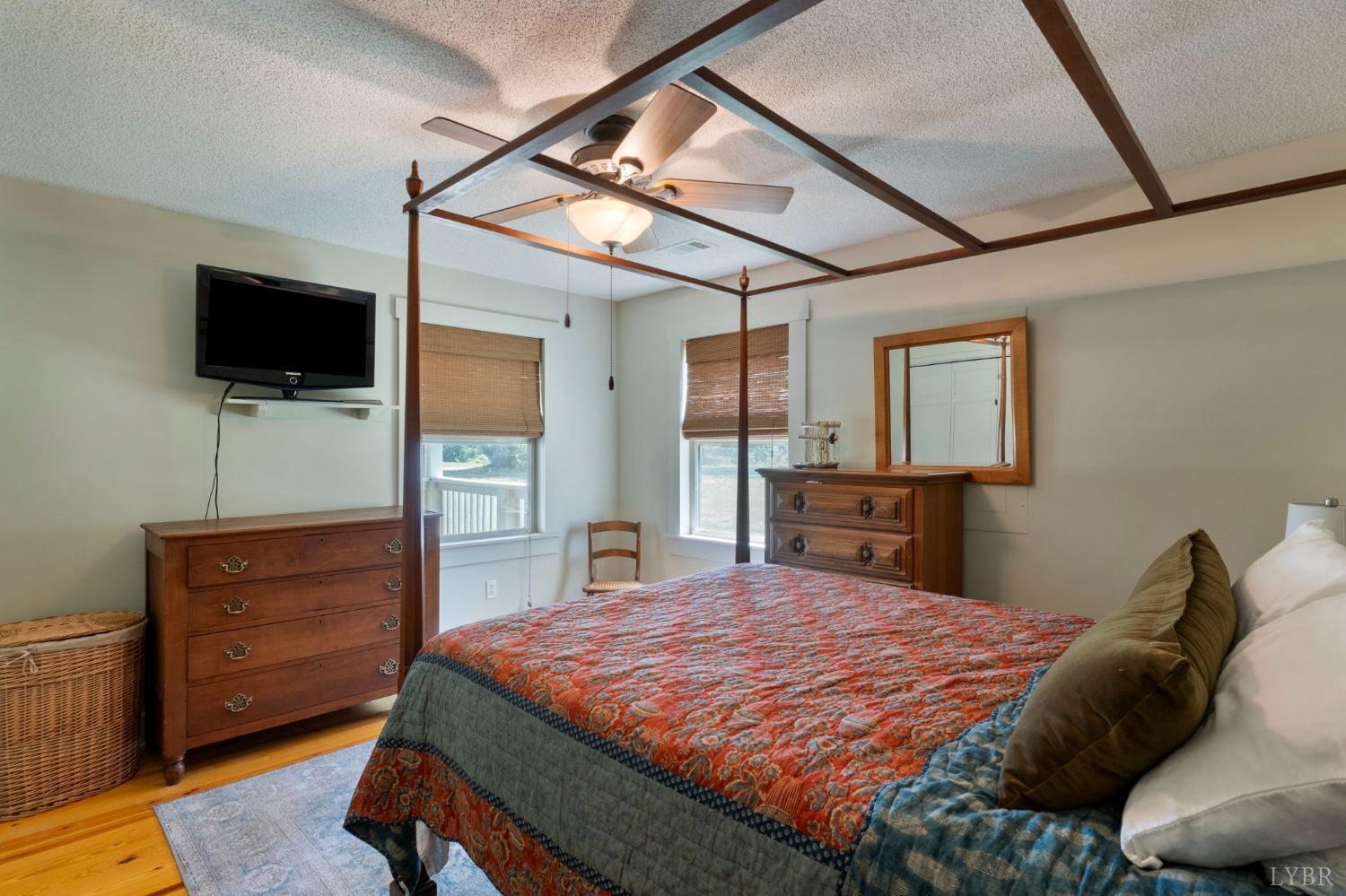 4466 Five Forks Road Pamplin, VA 23958 - Photo 13 of 34 a bedroom with a bed and a flat screen tv