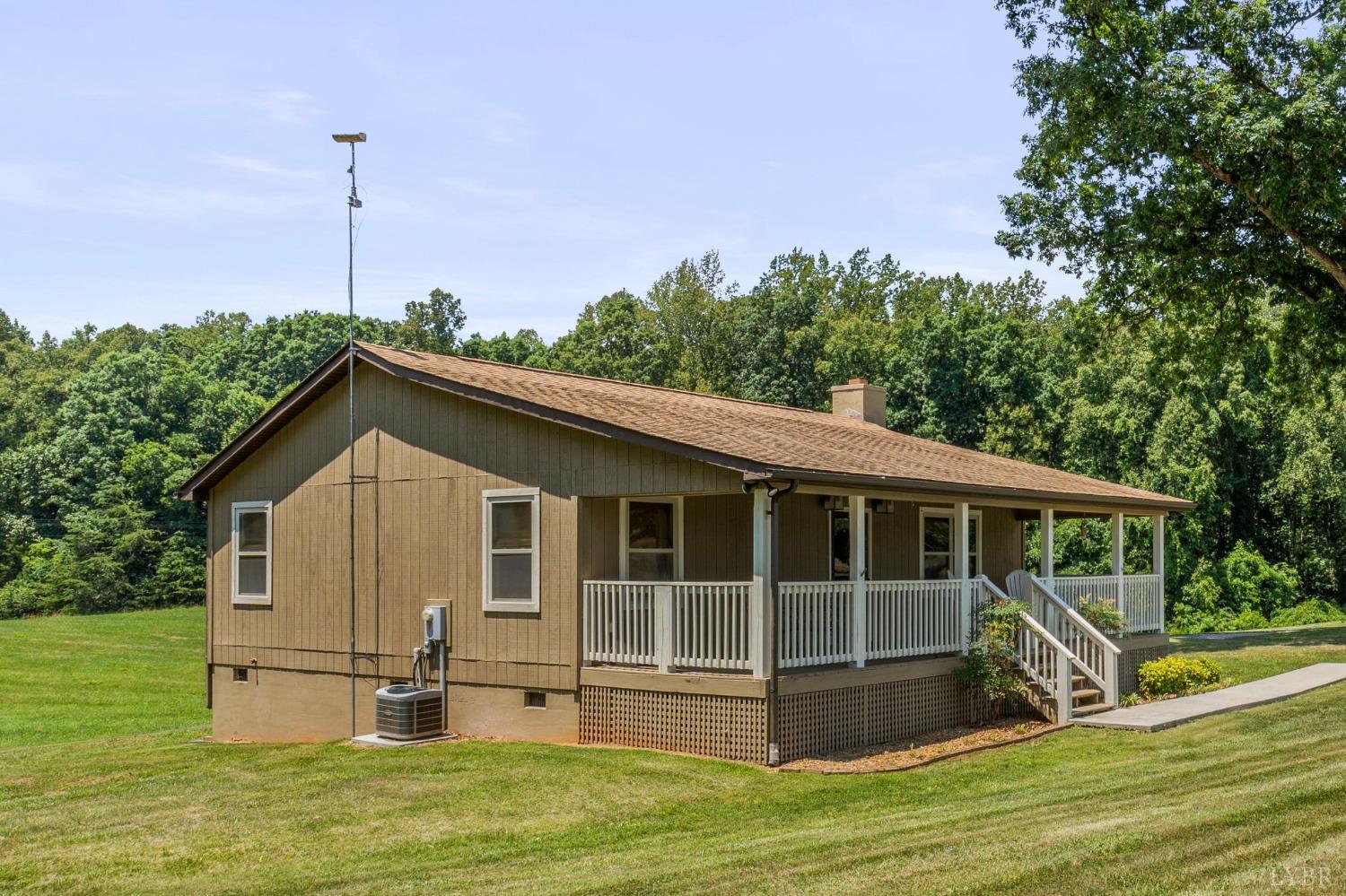 4466 Five Forks Road Pamplin, VA 23958 - Photo 23 of 34 a view of a house with a wooden deck and a big yard