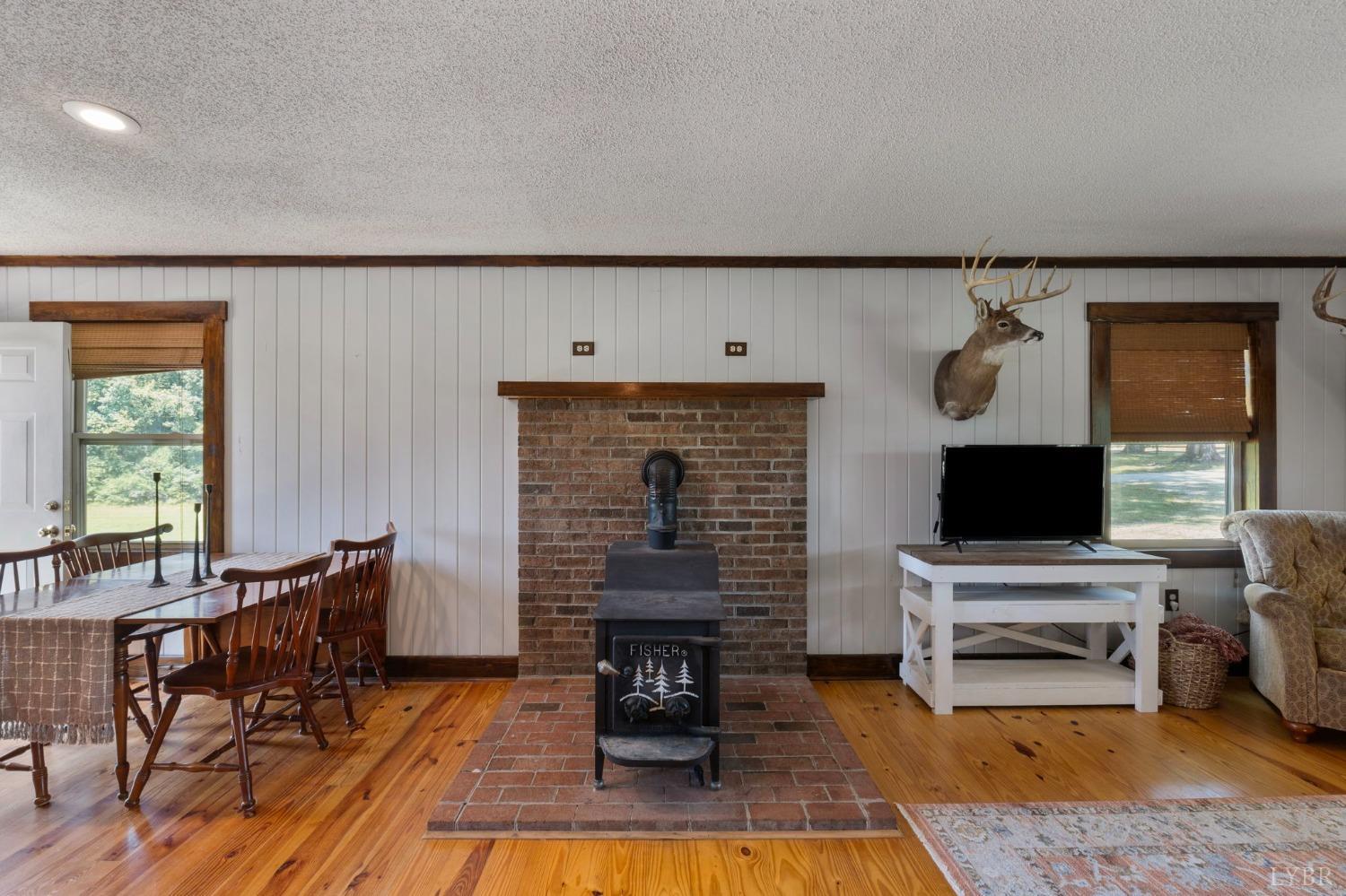 4466 Five Forks Road Pamplin, VA 23958 - Photo 6 of 34 a living room with furniture a fireplace and a flat screen tv