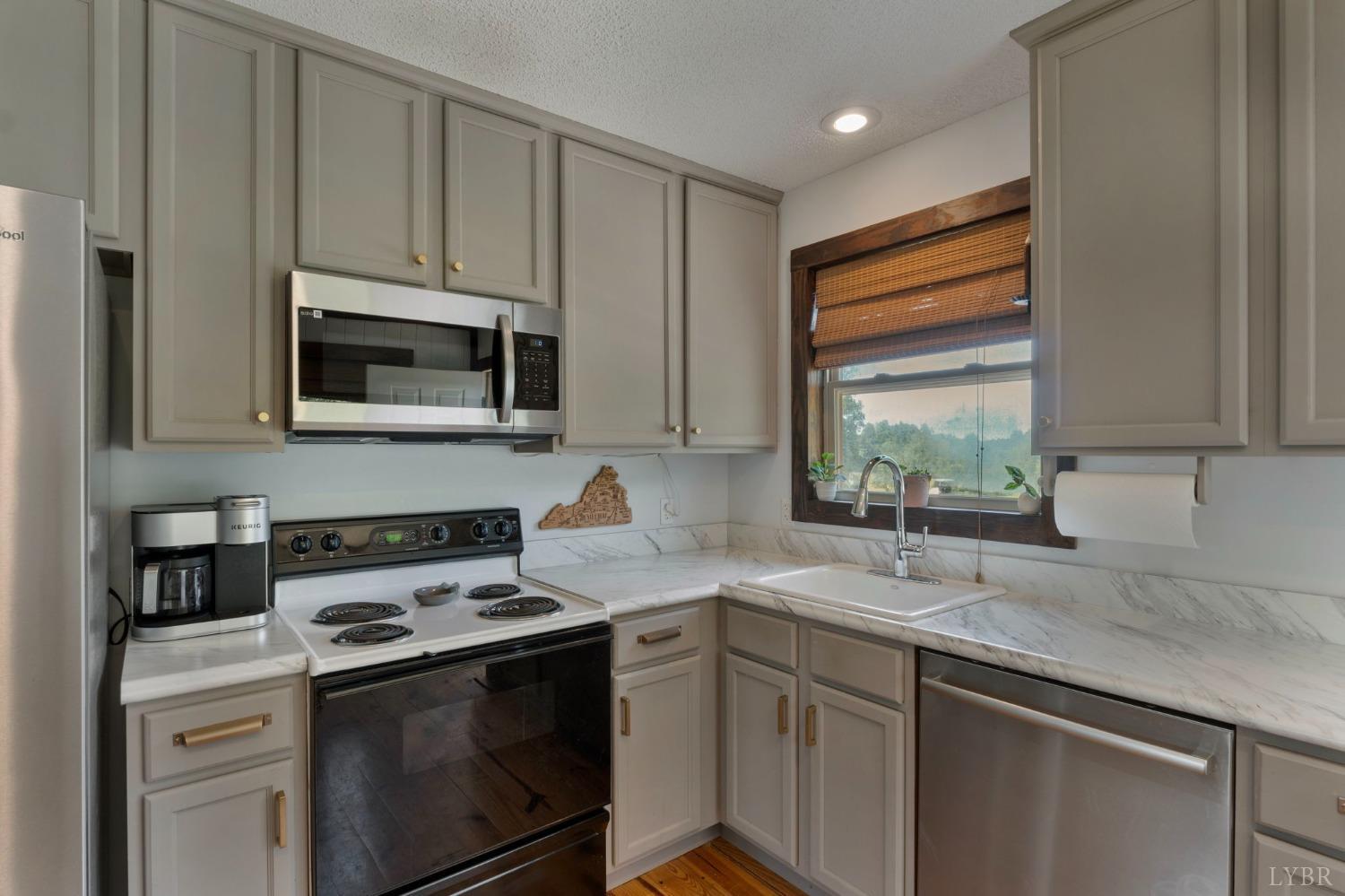 4466 Five Forks Road Pamplin, VA 23958 - Photo 10 of 34 a kitchen with a sink stove and microwave