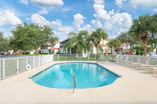 a view of a swimming pool with a patio and swimming pool