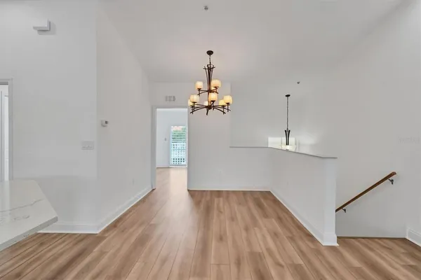 a view of a room with wooden floor and windows