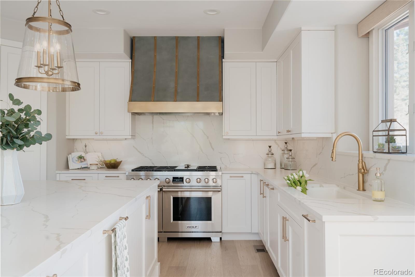 298 Fairchild Drive Highlands Ranch, CO 80126 - Photo 13 of 50 a kitchen with stainless steel appliances a sink stove and white cabinets