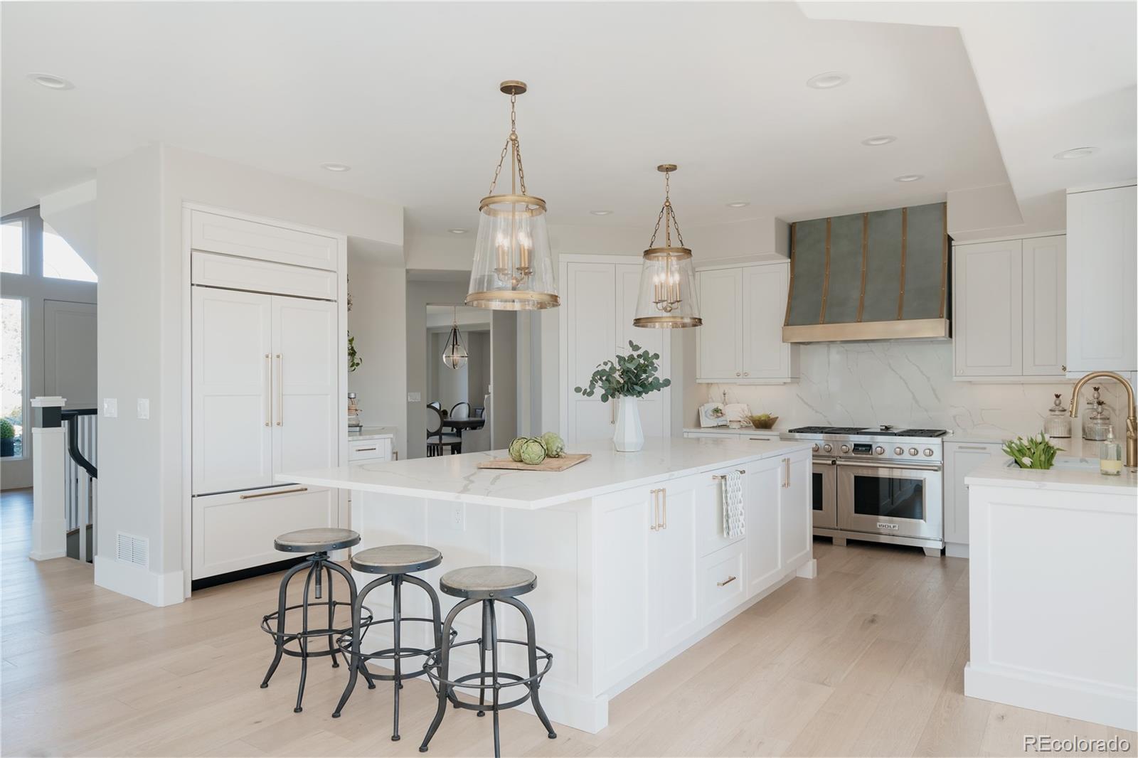 298 Fairchild Drive Highlands Ranch, CO 80126 - Photo 14 of 50 a kitchen with white cabinets and stainless steel appliances