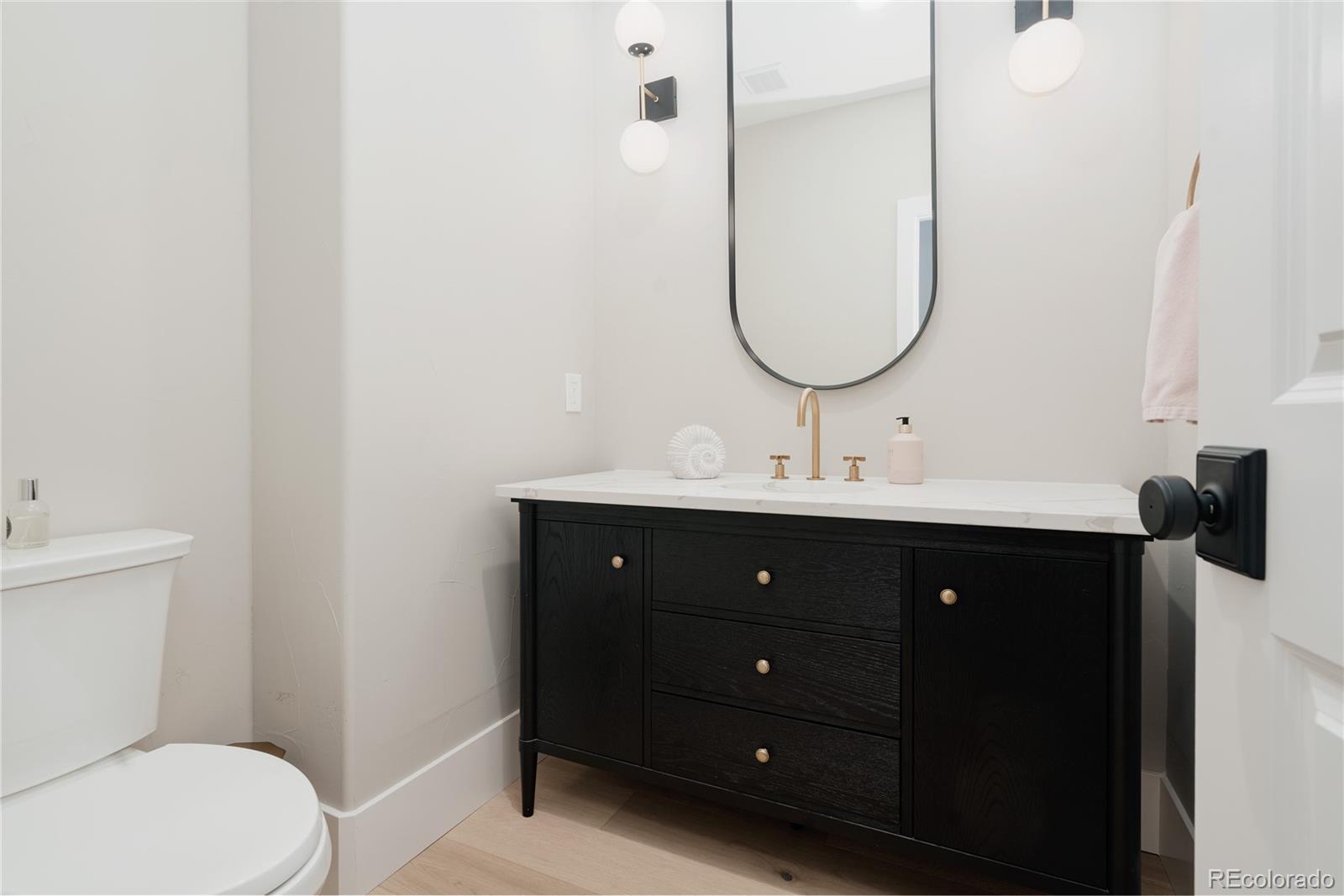 298 Fairchild Drive Highlands Ranch, CO 80126 - Photo 16 of 50 a bathroom with a sink vanity mirror and toilet