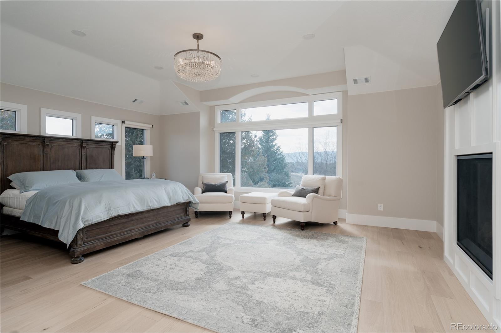 298 Fairchild Drive Highlands Ranch, CO 80126 - Photo 18 of 50 a bedroom with bed and large flat tv screen