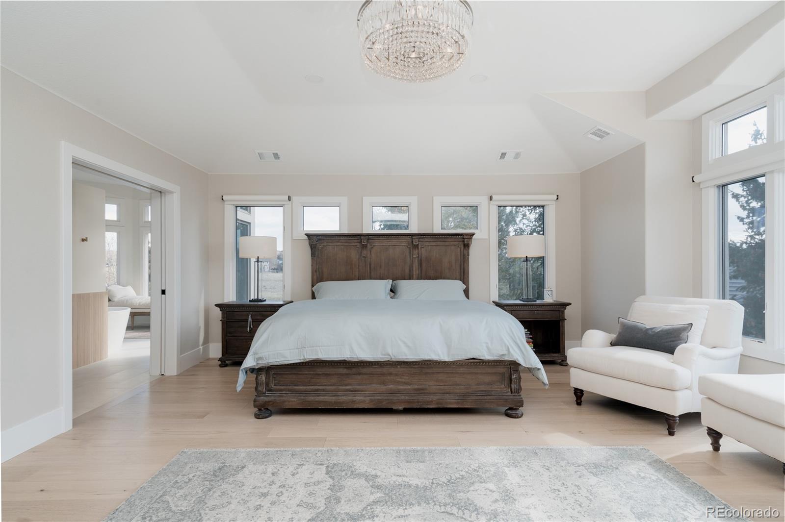 298 Fairchild Drive Highlands Ranch, CO 80126 - Photo 19 of 50 a spacious bedroom with a bed a couch and a window