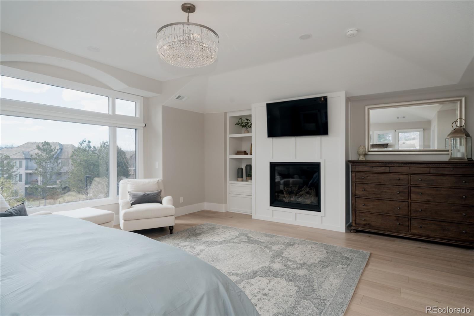 298 Fairchild Drive Highlands Ranch, CO 80126 - Photo 20 of 50 a living room with furniture a flat screen tv and a fireplace