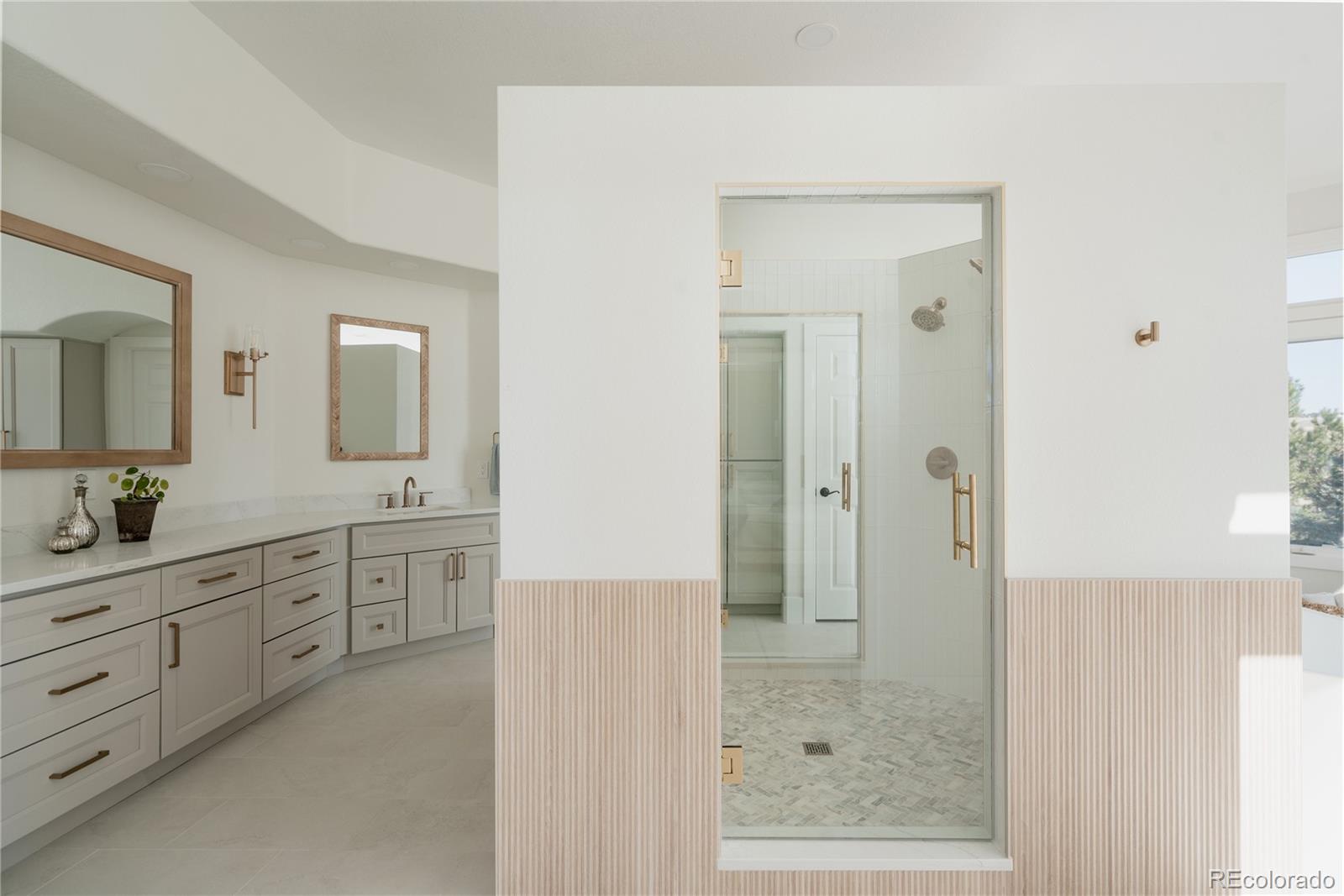 298 Fairchild Drive Highlands Ranch, CO 80126 - Photo 21 of 50 a bathroom with a shower sink and mirror