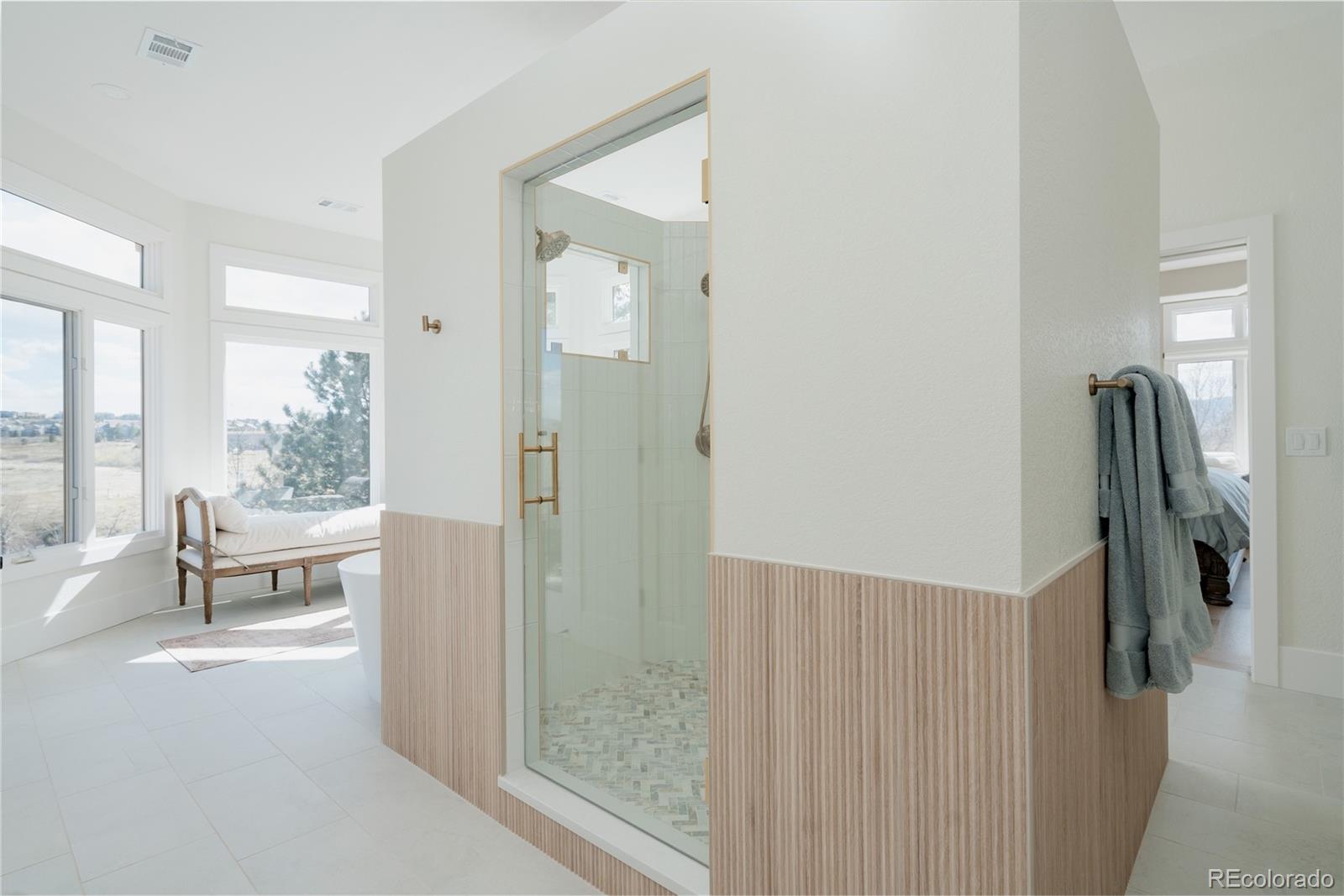298 Fairchild Drive Highlands Ranch, CO 80126 - Photo 22 of 50 a bathroom with a glass door shower and a sink
