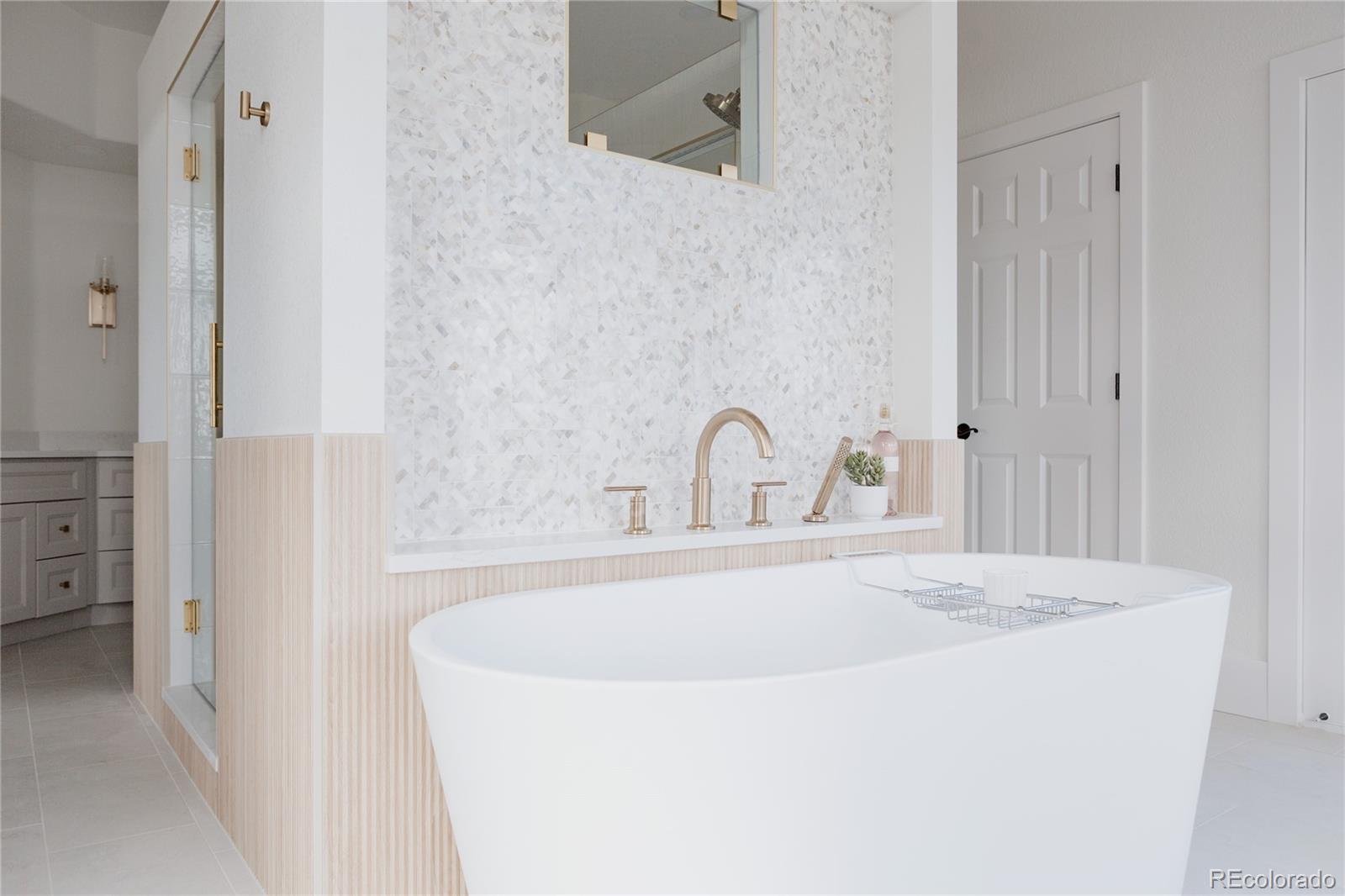 298 Fairchild Drive Highlands Ranch, CO 80126 - Photo 24 of 50 a bathroom with a tub