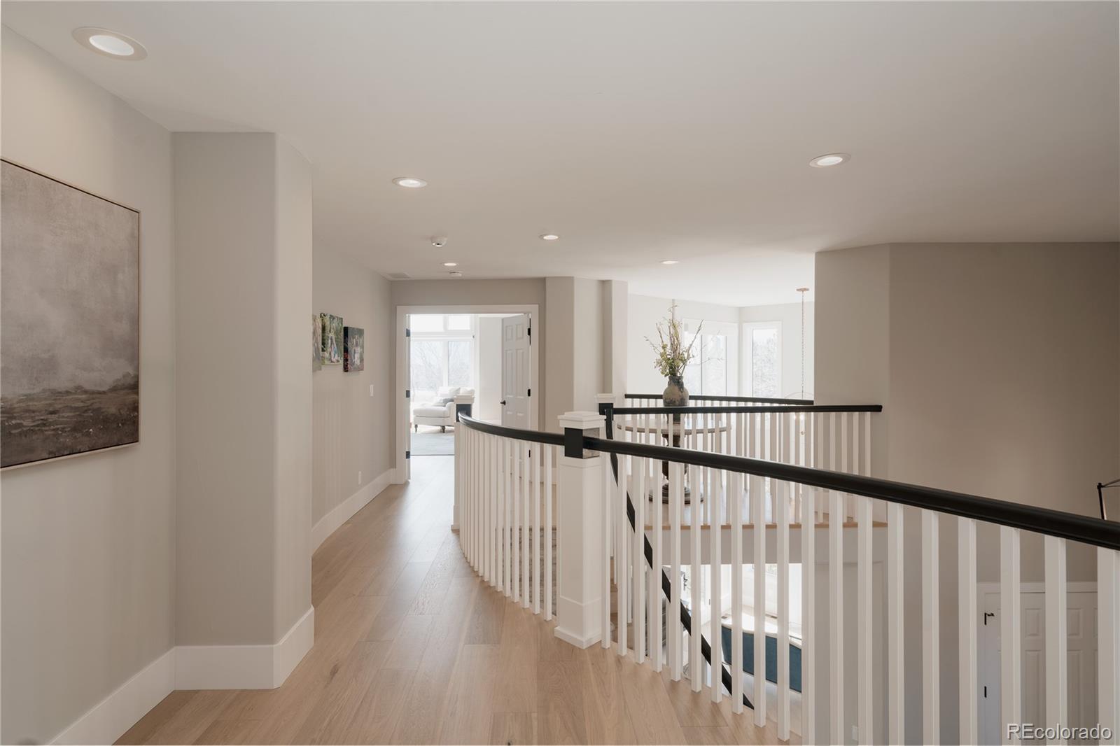 298 Fairchild Drive Highlands Ranch, CO 80126 - Photo 26 of 50 a view of a hallway with wooden floor
