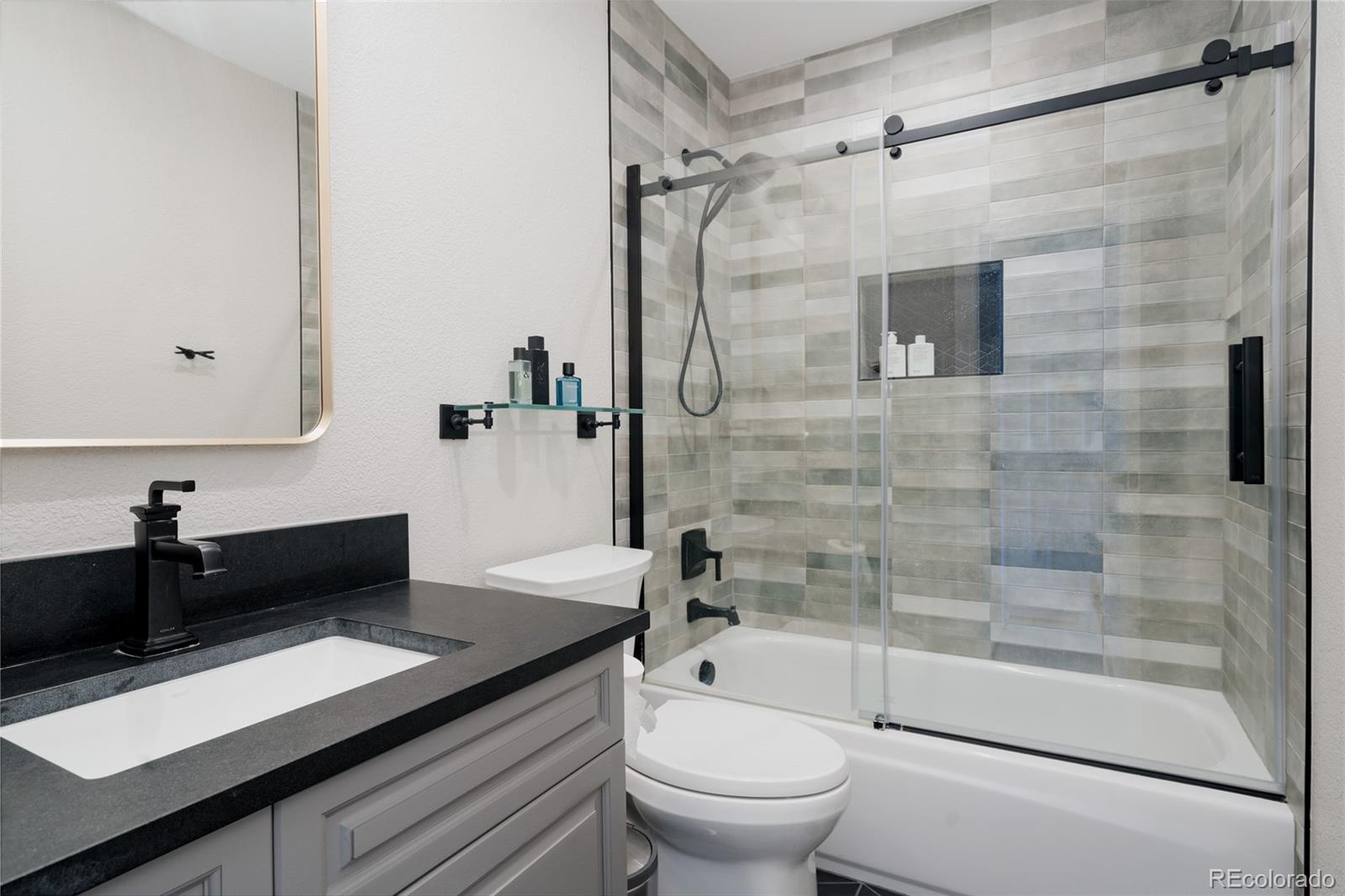 298 Fairchild Drive Highlands Ranch, CO 80126 - Photo 31 of 50 a bathroom with a granite countertop sink toilet and shower