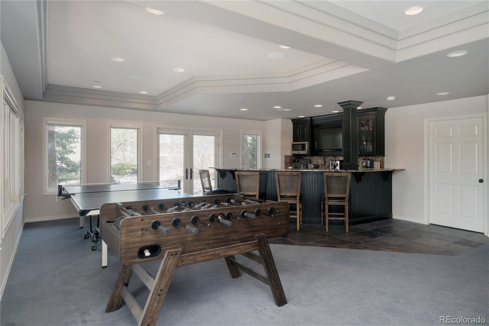 298 Fairchild Drive Highlands Ranch, CO 80126 - Photo 34 of 50 a living room with stainless steel appliances kitchen island granite countertop furniture and a view of kitchen