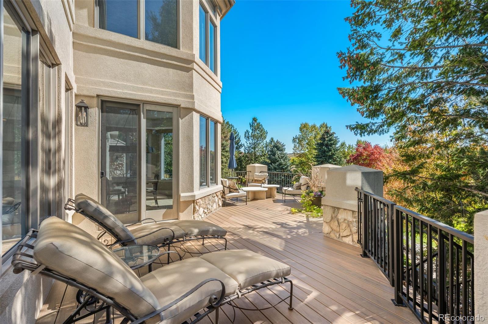 298 Fairchild Drive Highlands Ranch, CO 80126 - Photo 40 of 50 a view of a patio with table and chairs with wooden floor and fence