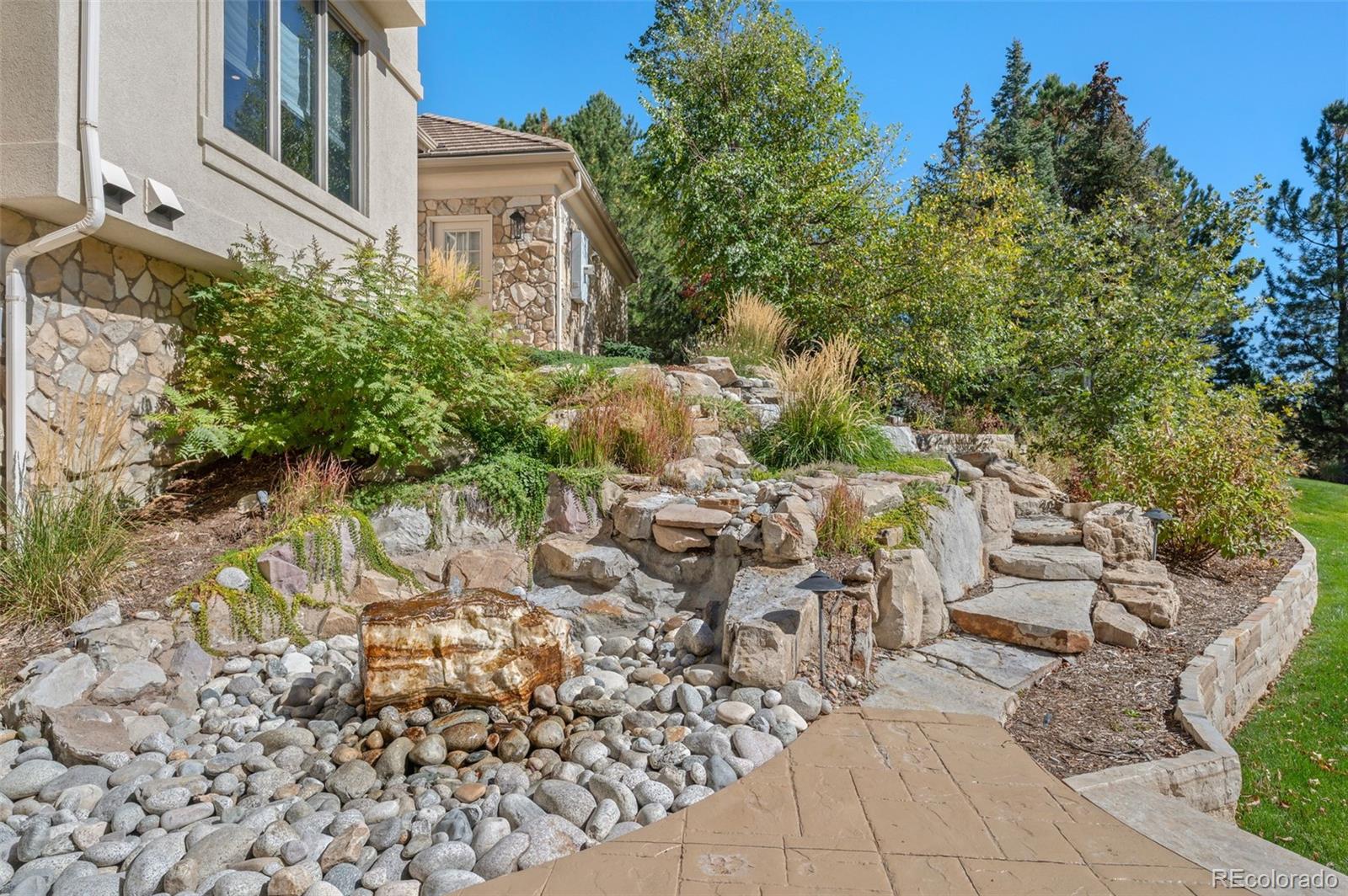 298 Fairchild Drive Highlands Ranch, CO 80126 - Photo 41 of 50 a view of a yard with plants and large trees