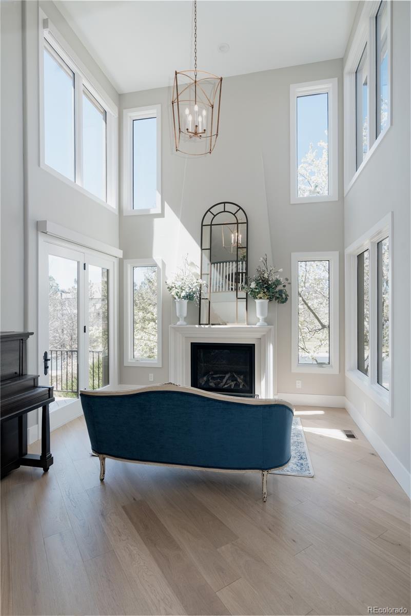 298 Fairchild Drive Highlands Ranch, CO 80126 - Photo 6 of 50 a living room with fireplace furniture and a large window