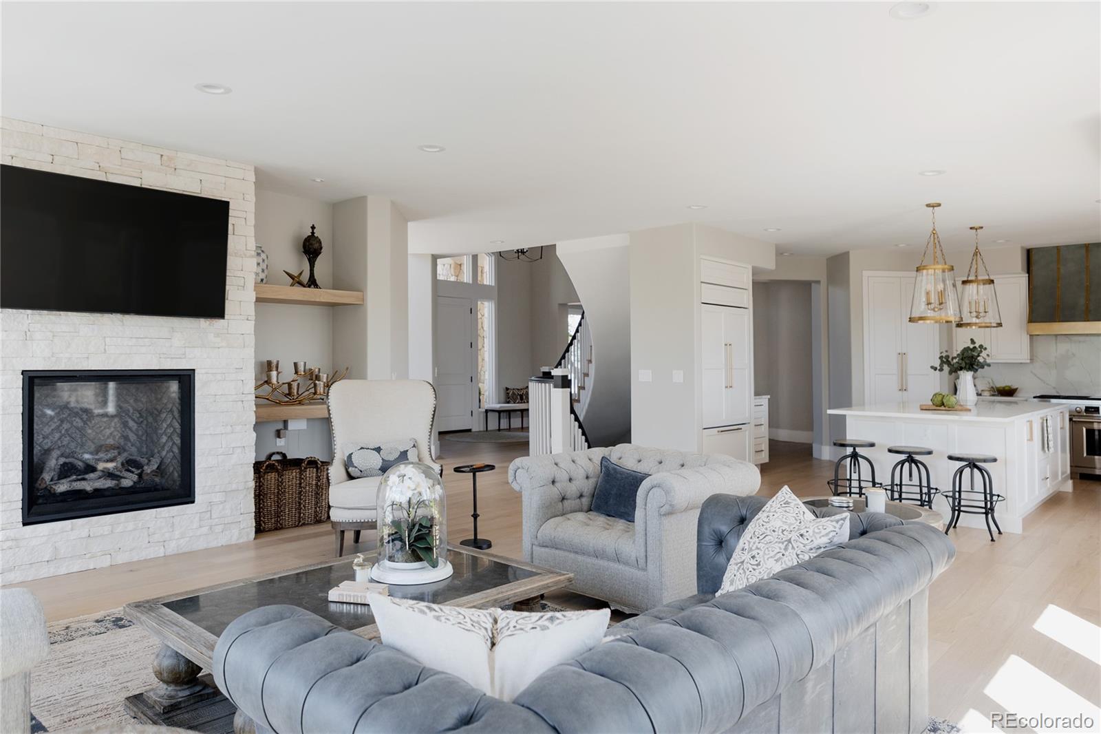 298 Fairchild Drive Highlands Ranch, CO 80126 - Photo 10 of 50 a living room with furniture a flat screen tv and a fireplace