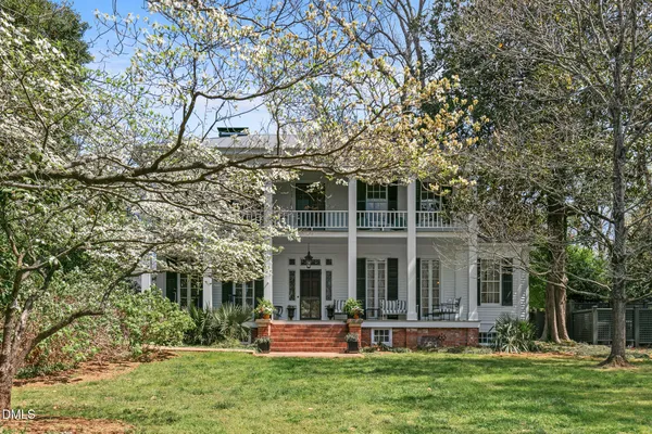 a view of a house with a yard porch and sitting area