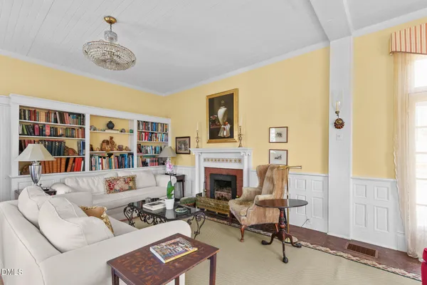 a living room with a bed furniture and a window