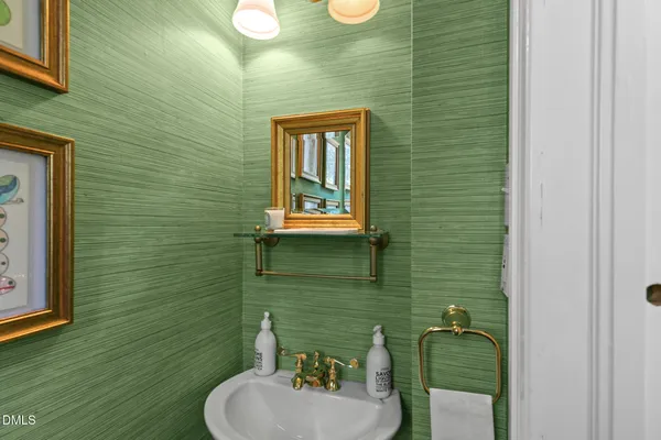 a bedroom with a bed mirror and a window