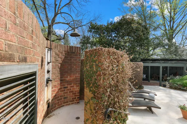 a living room with furniture a chandelier and a fireplace