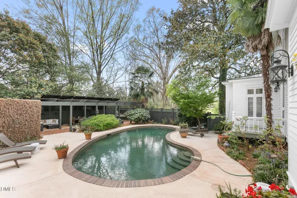 a view of a house with backyard and sitting area