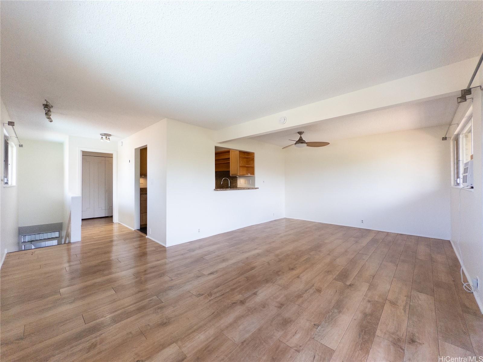 444 Lunalilo Home Road, Unit 506 Honolulu, HI 96825 - Photo 11 of 13 a view of a livingroom with wooden floor and a window