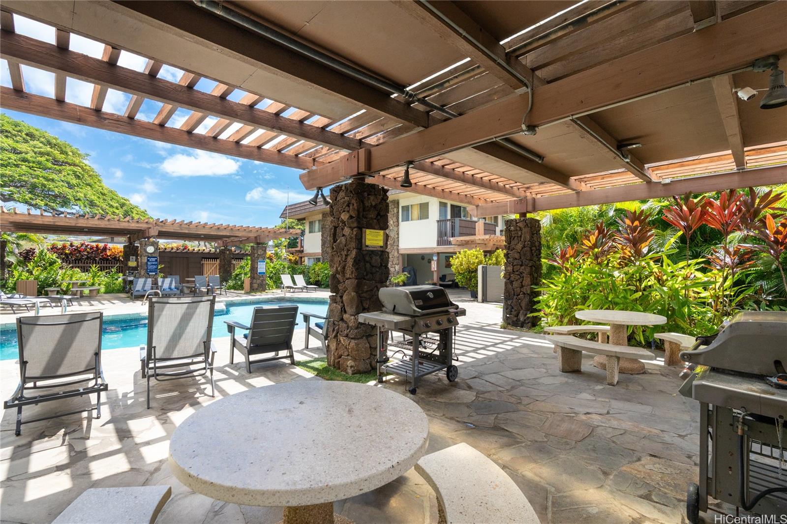 444 Lunalilo Home Road, Unit 506 Honolulu, HI 96825 - Photo 2 of 13 a view of a chairs and table in patio with a backyard