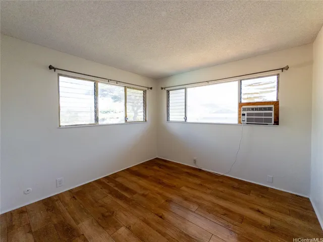 a view of a room with wooden floor and windows