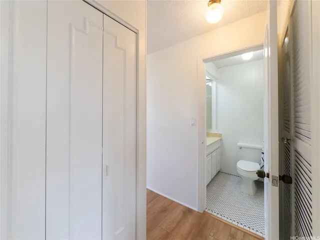 a bathroom with a granite countertop toilet and a shower
