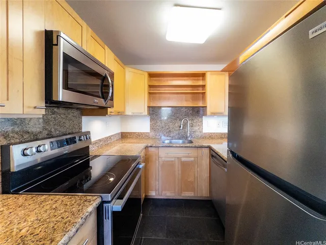 a kitchen with a sink stove and microwave