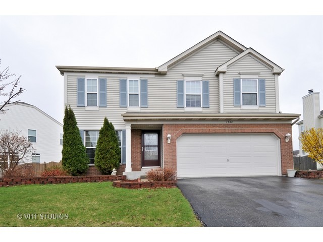 1544 Suncrest Lane Bolingbrook, IL 60490 - Photo 1 of 15 a front view of a house with a yard and trees