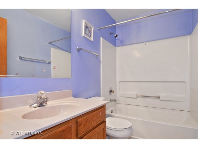 1544 Suncrest Lane Bolingbrook, IL 60490 - Photo 13 of 15 a bathroom with a sink a toilet and shower
