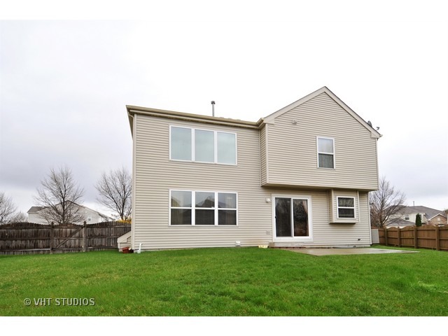 1544 Suncrest Lane Bolingbrook, IL 60490 - Photo 14 of 15 a front view of a house with a garden