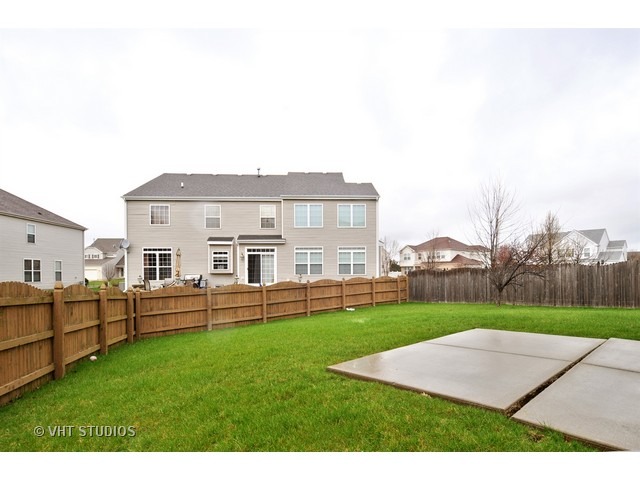 1544 Suncrest Lane Bolingbrook, IL 60490 - Photo 15 of 15 a view of a house with a yard and sitting area