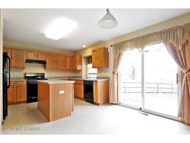 1544 Suncrest Lane Bolingbrook, IL 60490 - Photo 4 of 15 a kitchen with stainless steel appliances granite countertop a stove a sink and a refrigerator