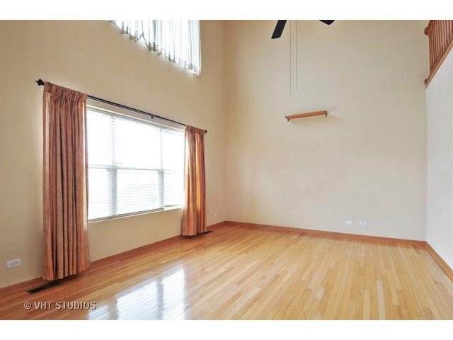 1544 Suncrest Lane Bolingbrook, IL 60490 - Photo 6 of 15 a view of an empty room with wooden floor and a window