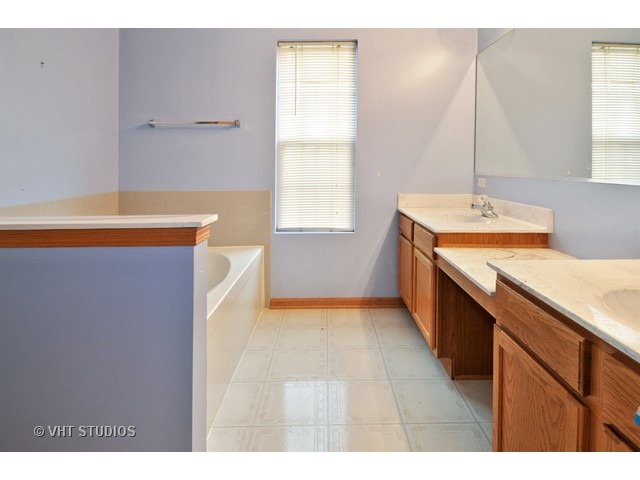1544 Suncrest Lane Bolingbrook, IL 60490 - Photo 10 of 15 a kitchen with stainless steel appliances a sink a stove and a window
