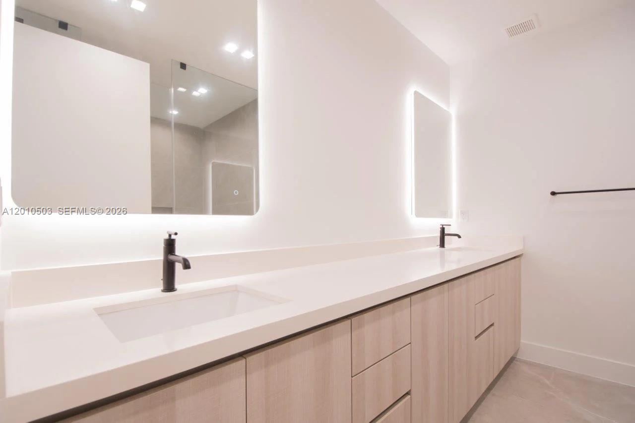 6802 Southwest 80th Street, Unit 6802 Miami, FL 33143 - Photo 6 of 9 a bathroom with a sink and a mirror