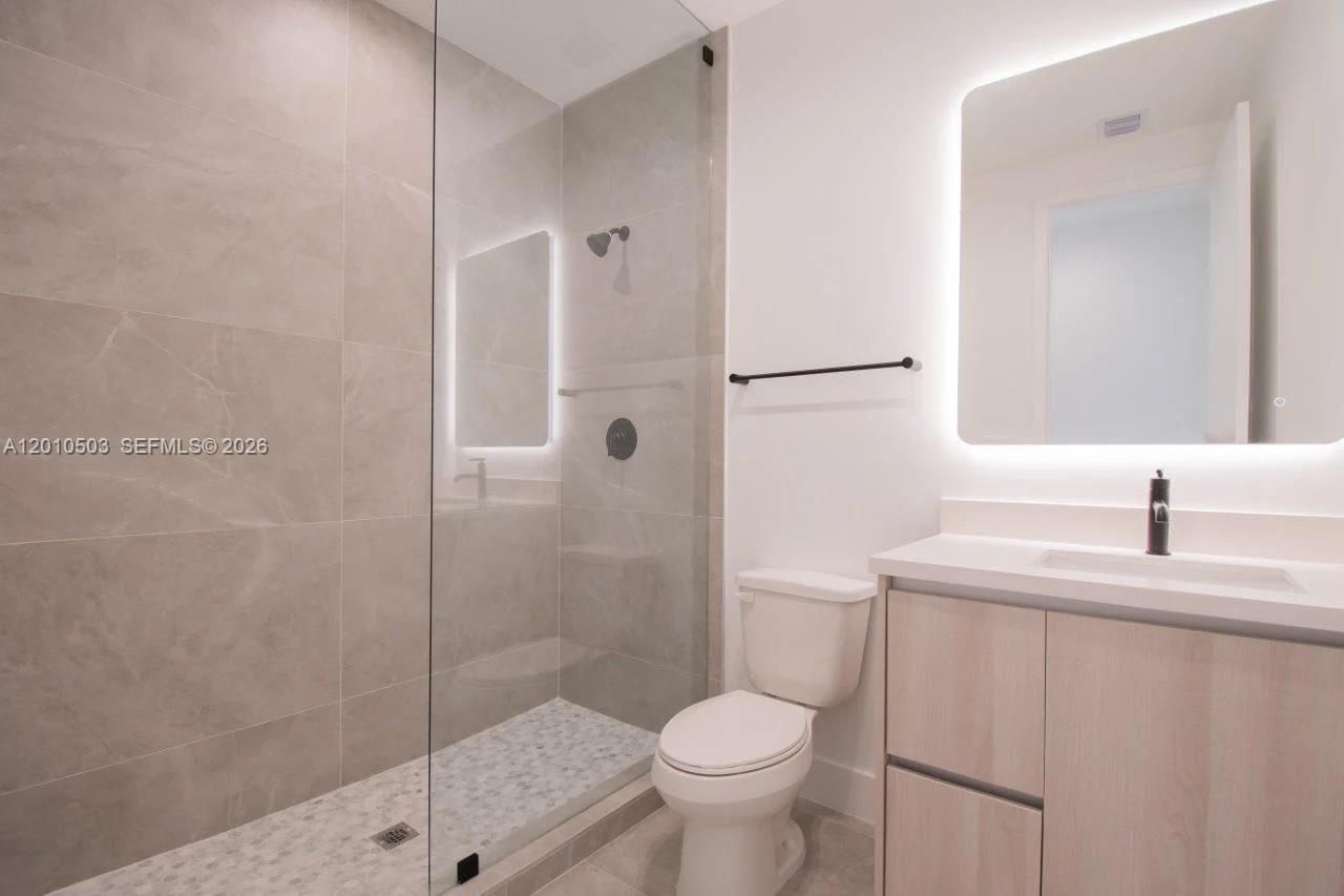 6802 Southwest 80th Street, Unit 6802 Miami, FL 33143 - Photo 7 of 9 a bathroom with a sink toilet and shower