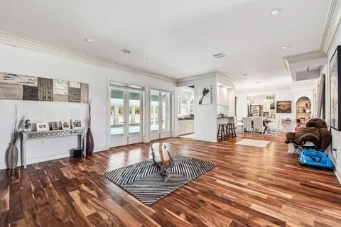 a living room with furniture and wooden floor