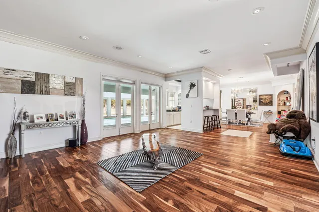 a living room with furniture and wooden floor