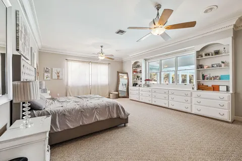 a bedroom with a bed a dresser and a window