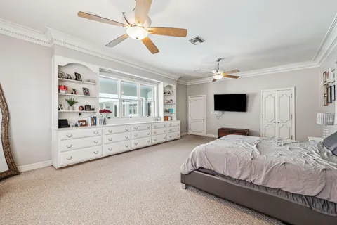 a spacious bedroom with a bed and a flat screen tv