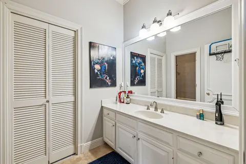 a bathroom with a double vanity sink and a mirror