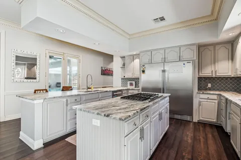 a kitchen with a stove top oven sink and refrigerator
