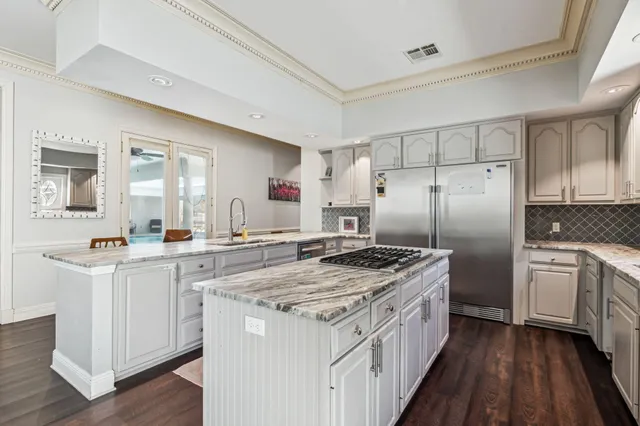 a kitchen with a stove top oven sink and refrigerator