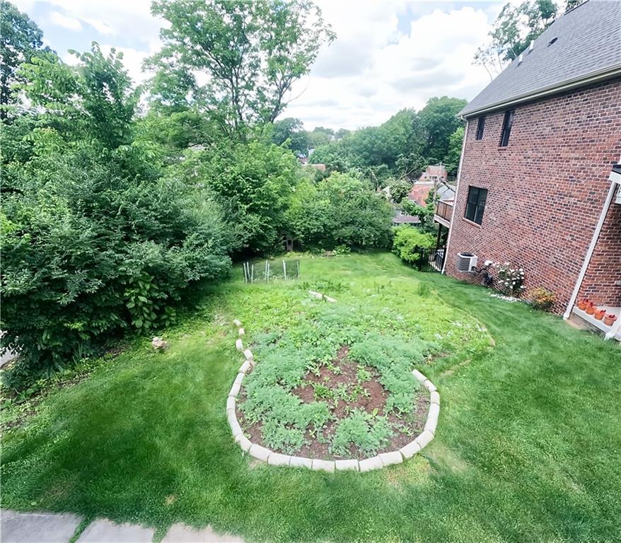 318 Garland Street Pittsburgh, PA 15218 - Photo 4 of 8 a view of a backyard with a garden